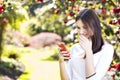 Beautiful girl reading text message on her smart phone in the ga Royalty Free Stock Photo