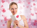 Beautiful girl reads a postcard valentine