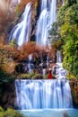 Beautiful girl in red dress at Thi Lo Su waterfallTee Lor Su in Tak province. Thi Lo Su waterfall the largest waterfall in