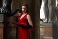 Beautiful girl in a red dress for a walk in St. Petersburg