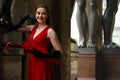 Beautiful girl in a red dress for a walk in St. Petersburg