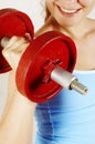 Beautiful girl and red dumbbell Royalty Free Stock Photo