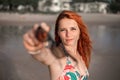 Beautiful girl with red hair posing on the beach. Sunset. Royalty Free Stock Photo