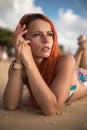 Beautiful girl with red hair posing on the beach. Sunset. Royalty Free Stock Photo