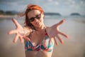 Beautiful girl with red hair posing on the beach. Sunset. Royalty Free Stock Photo