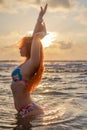 Beautiful girl with red hair posing on the beach. Sunset. Royalty Free Stock Photo