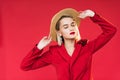 beautiful girl in red jacket with boutonniere and straw hat, Royalty Free Stock Photo