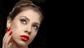 Beautiful girl with red lipstick and nail polish on a dark background Royalty Free Stock Photo