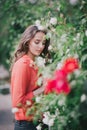 Beautiful girl in a red shirt posing on a street