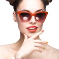 Beautiful girl in red sunglasses with bright makeup and colorful nails. Beauty face. Royalty Free Stock Photo