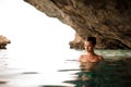 Beautiful girl with redhead tied hair in the water cave Royalty Free Stock Photo