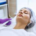 Beautiful woman on rejuvenation procedure in beauty clinic. Royalty Free Stock Photo