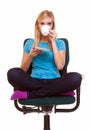 Beautiful girl relaxing in chair holds a cup of tea or coffee. Royalty Free Stock Photo