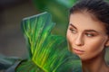 Beautiful girl resting and enjoying vacation in tropical forest. Close-up of sensual young brunette woman under palm trees. Royalty Free Stock Photo