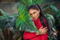 Beautiful girl resting and enjoying vacation in tropical forest. Close-up of sensual young brunette woman under palm trees. Royalty Free Stock Photo