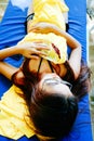 Beautiful girl resting on sunbed during vacation on the beach. Relaxed woman sunbathing and relaxing lying on deck chair at tropic Royalty Free Stock Photo