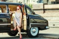 Beautiful girl in retro style and a vintage car Royalty Free Stock Photo