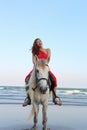 Beautiful girl ride horse at the sea
