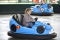 beautiful girl riding a bumper car in an amusement park Royalty Free Stock Photo