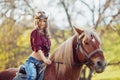 Beautiful girl riding horse on autumn field Royalty Free Stock Photo