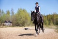 Beautiful girl riding a horse on manege