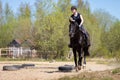 Beautiful girl riding a horse on manege