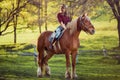 Beautiful girl riding horse on summer field Royalty Free Stock Photo