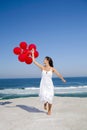 Beautiful girl running with red ballons Royalty Free Stock Photo