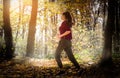 Beautiful girl running trough forest in autumn Royalty Free Stock Photo