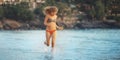 Beautiful girl runs along beach Royalty Free Stock Photo