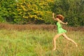 Beautiful girl runs on a glade Royalty Free Stock Photo