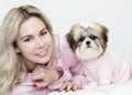 Beautiful girl with shih tzu, smiling with a puppy, in pink clothes