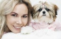 Beautiful girl with shih tzu, smiling with a puppy, in pink clothes