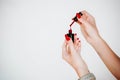 Beautiful girl showing red manicure nails. red nail polish bottle on white background. Stylish trendy female manicure. Royalty Free Stock Photo