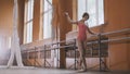 Beautiful girl shows amazing flexibility of the legs of the ballet bar