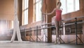 Beautiful girl shows amazing flexibility of the legs of the ballet bar