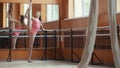 Beautiful girl shows amazing flexibility of the legs of the ballet bar