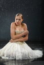 Beautiful girl sits on floor, freezes in rain Royalty Free Stock Photo