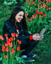 Beautiful girl sits on a flower meadow and photographed Royalty Free Stock Photo