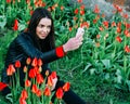 Beautiful girl sits on a flower meadow and photographed Royalty Free Stock Photo