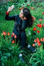 Beautiful girl sits on a flower meadow and photographed Royalty Free Stock Photo