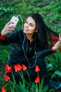 Beautiful girl sits on a flower meadow and photographed Royalty Free Stock Photo