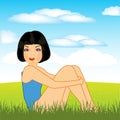 Beautiful girl sits on green year glade