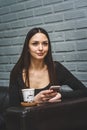 Beautiful girl sitting in a beauty salon and drinking coffee