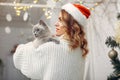 Beautiful girl sitting on a bed with cute kitty Royalty Free Stock Photo