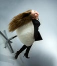 Beautiful girl is sitting in a chair Royalty Free Stock Photo