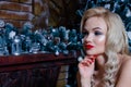 Beautiful girl sitting chair near the fireplace and the Christmas tree Royalty Free Stock Photo