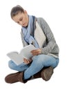 Beautiful girl sitting cross-legged, reading a book on a white Royalty Free Stock Photo