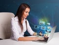 Beautiful girl sitting at desk and watching her photo gallery on Royalty Free Stock Photo