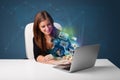 Beautiful girl sitting at desk and watching her photo gallery on Royalty Free Stock Photo